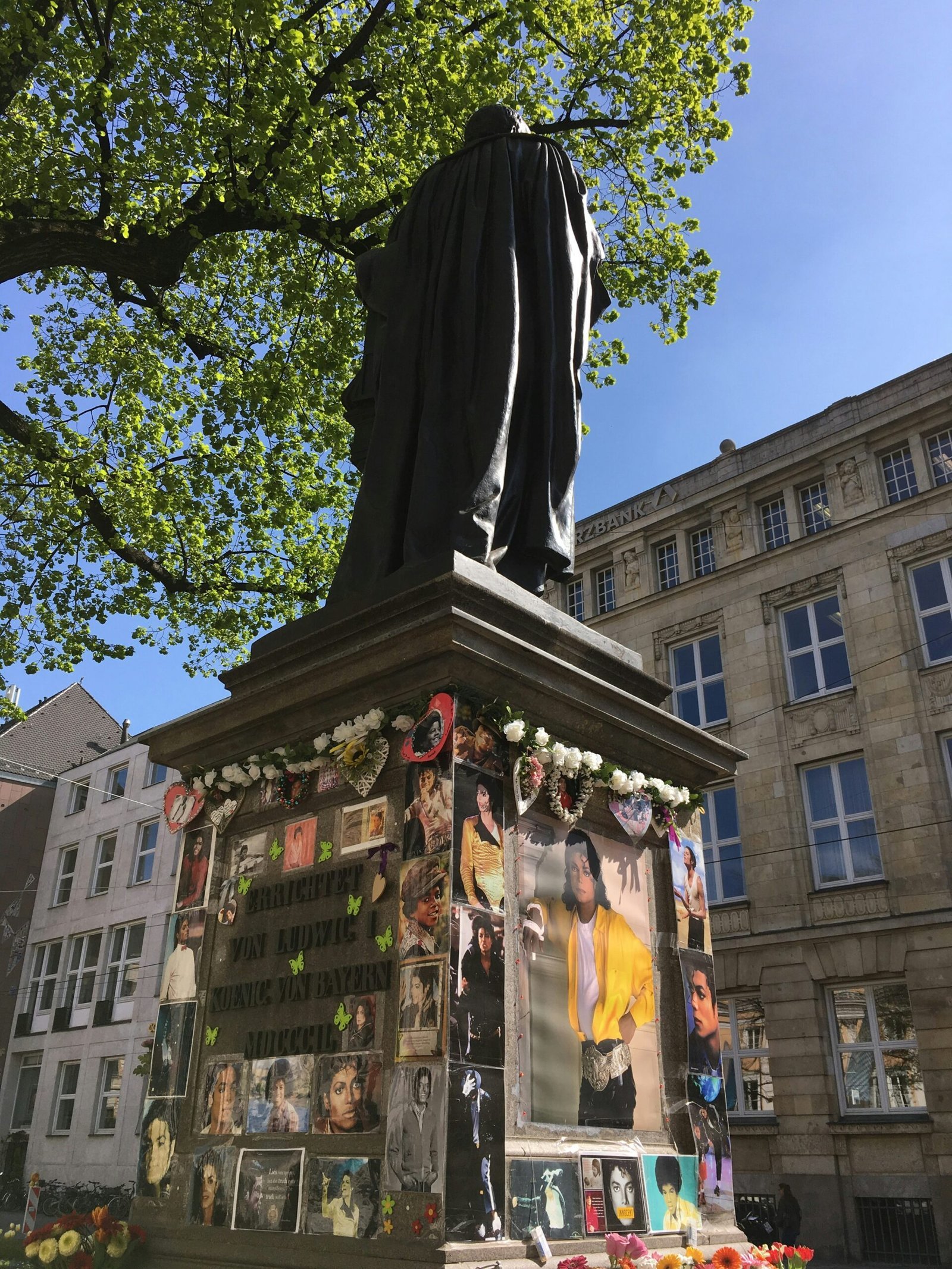 black statue near green tree during daytime