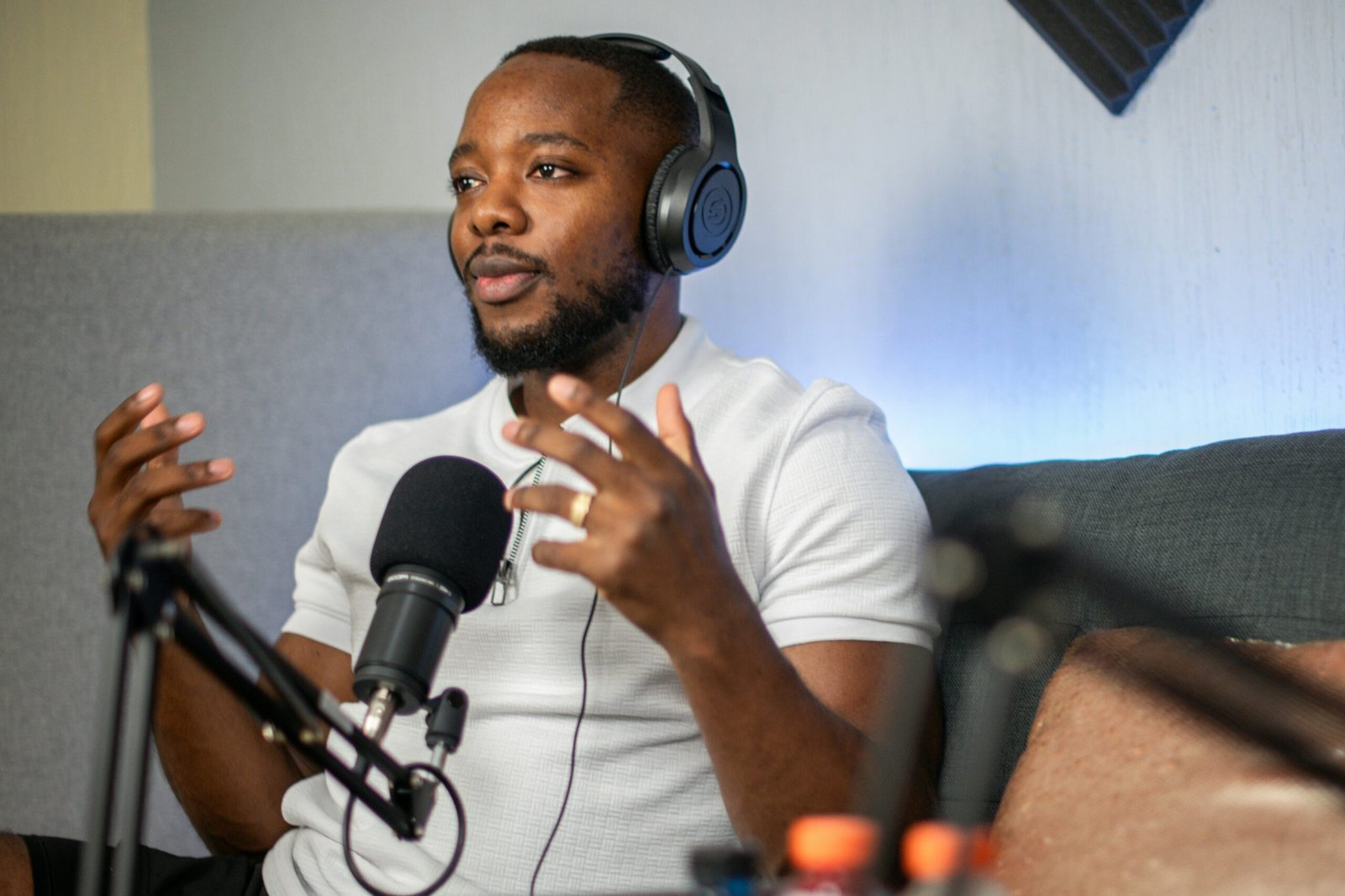 a man wearing headphones sitting in front of a microphone