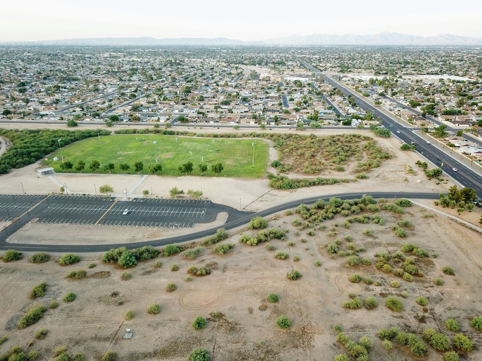 An aerial view of a parking lot and a highway